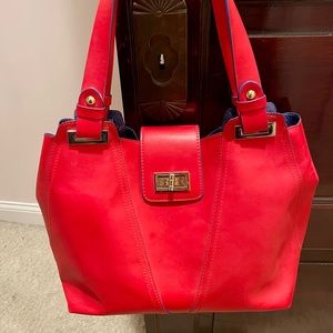 Red leather designer handbag with blue interior lining